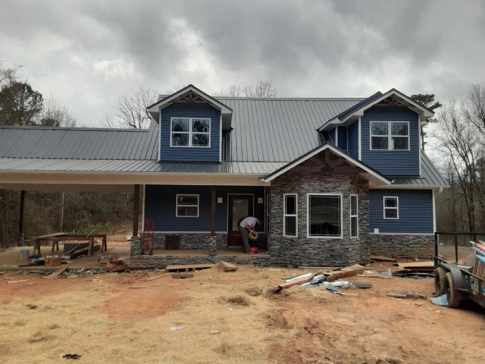 Soffit, Fascia, and Gutters: Aluminum color white 
Siding: Vinyl variform 
             Color Bayou Blue
 Ceilings: Corrugated Tin
